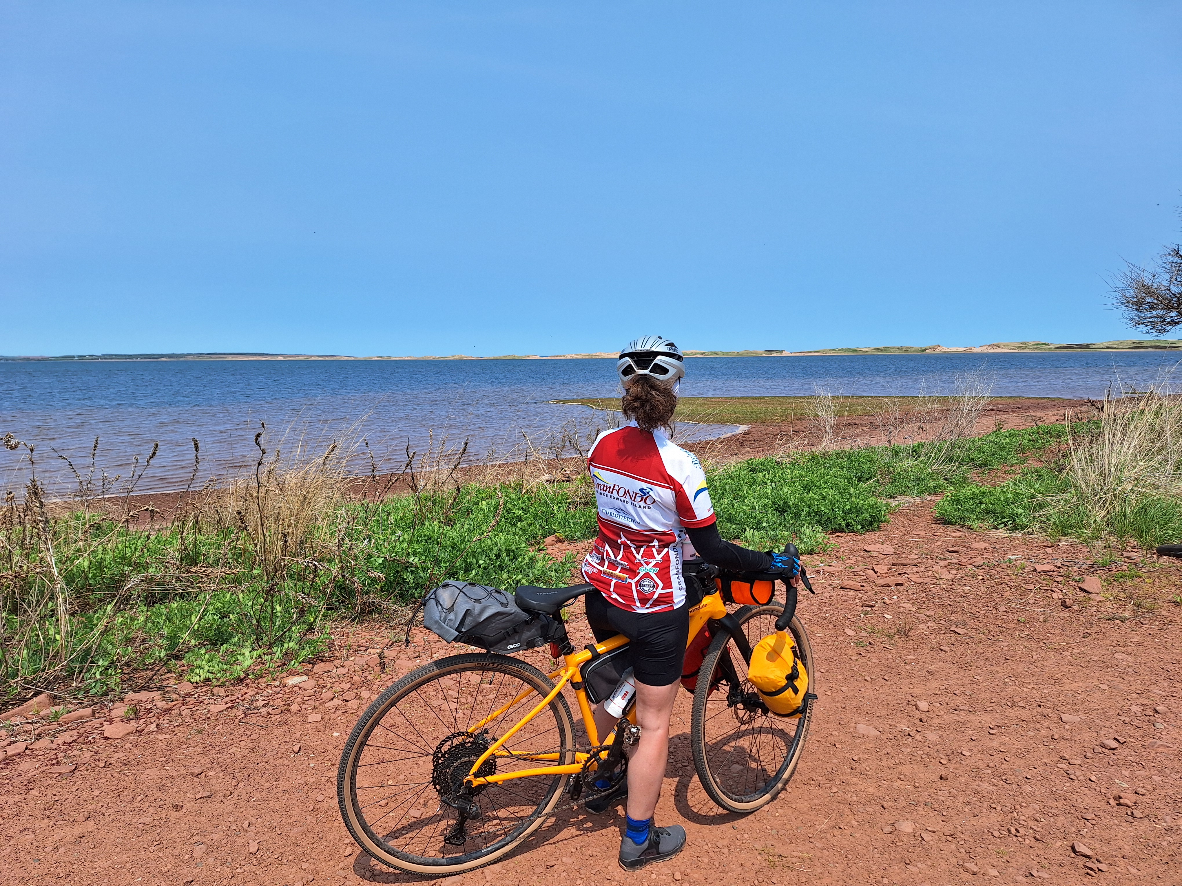 Cyclists on a red gravel road